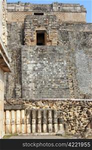 Wall of temple and pyramid in Uxmal, Mexico