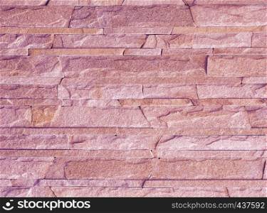 Wall stone mosaic made of pink sandstone texture. Stone mosaic of light pink sandstone texture.
