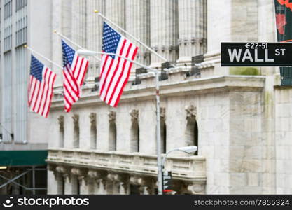 Wall street sign in New York with New York Stock Exchange background