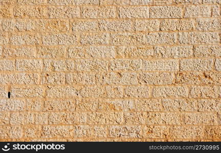 Wall texture built of yellow stone blocks