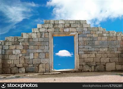 Wall with entrance to the beautiful cloudscape