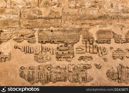 Wall with ruined writings and hierogliphs in Luxor Temple. Wall with ruined writings