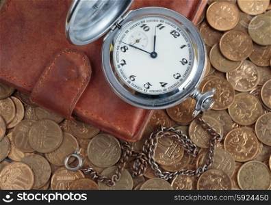 Wallet and pocket watch on the coins background