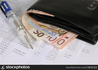 Wallet with different banknotes and pen on banking report