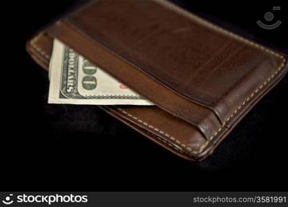 wallet with hundred dollars bill on black background