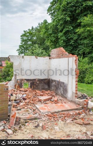 Walls and bricks of demolished house with trees