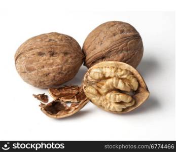 walnut and a cracked walnut isolated on the white background with clipping past