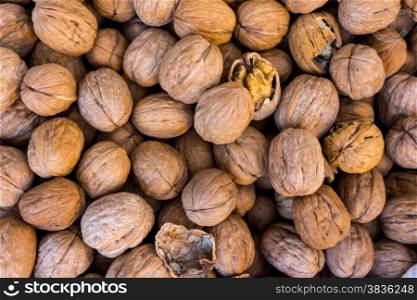 Walnut background. lot of walnuts in the peel