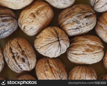 walnut fruit food background. many walnuts with shell useful as a background