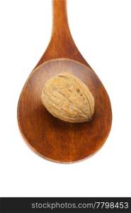 walnut in a wooden spoon isolated on white