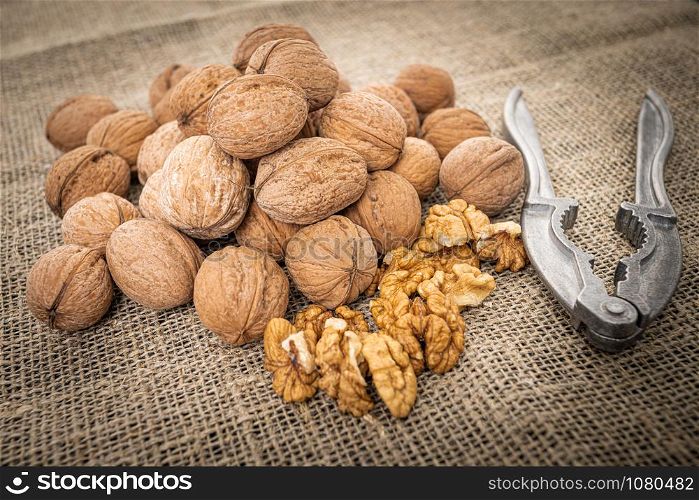 Walnut kernel background. Nutcracker with walnut