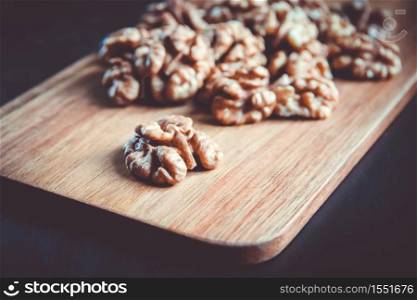 Walnut kernels on a wooden cutting board. Walnut kernels on a cutting board