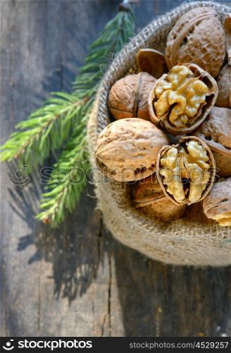 walnuts in a bag on a wooden background