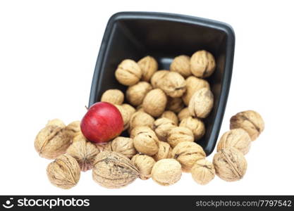 walnuts in a bowl and apples isolated on white