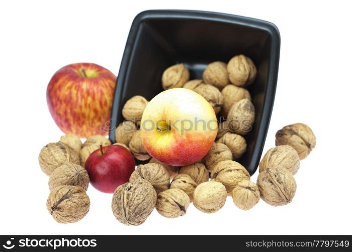 walnuts in a bowl and apples isolated on white