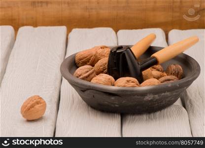 Walnuts in a bowl on a wooden table.