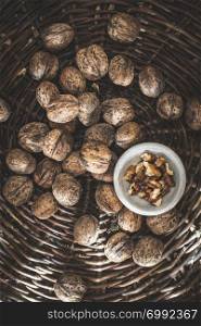 Walnuts in a vintage basket. Natural light. Bowl with walnuts.