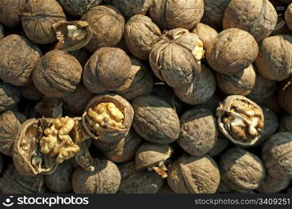 Walnuts in shell. Some of them broken