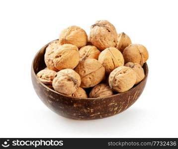 Walnuts in wooden bowl isolated on a white background. Whole nuts in a coconut bowl