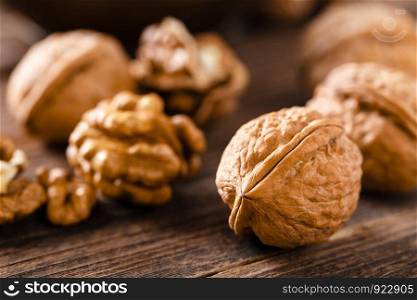 Walnuts. Kernels and whole nuts on wooden rustic table