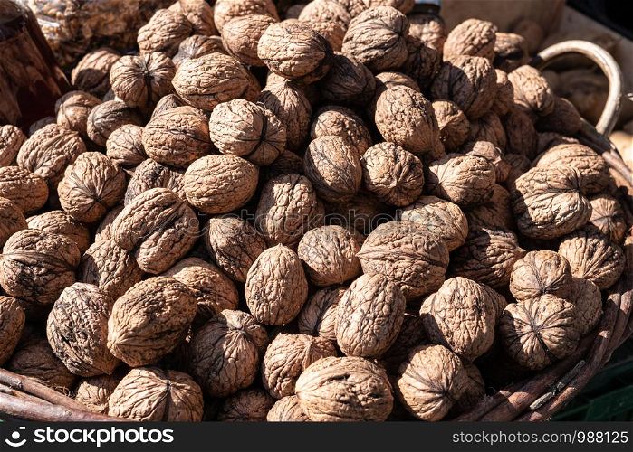Walnuts on a basket. Food background