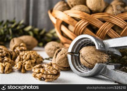Walnuts on a white table, walnut kernels. Healthy food from walnut. Walnuts in a basket with a vine.. Walnuts on a white table, walnut kernels. Healthy food of walnut. Walnuts in the basket.