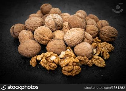 Walnuts on black background. Group walnuts on Healthy organic food concept.