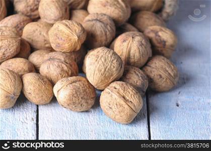 Walnuts on wooden table in the kitchen.