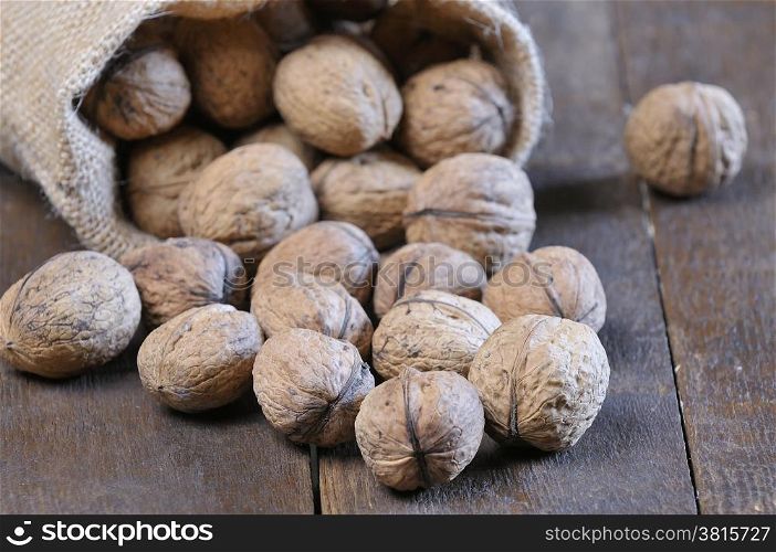 Walnuts on wooden table in the kitchen.