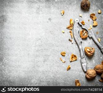 Walnuts with Nutcracker. On the stone table.. Walnuts with Nutcracker.