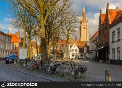 Walplein square in the beautiful medieval city Brugge at morning, Belgium. In the foreground is parking bicycles, in the background Church of Our Lady.