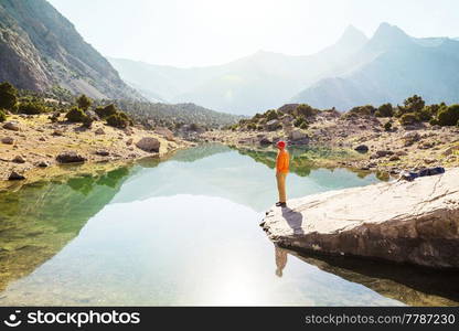 Wanderlust time. Man hiking in beautiful Fann mountains in Pamir, Tajikistan. Central Asia.