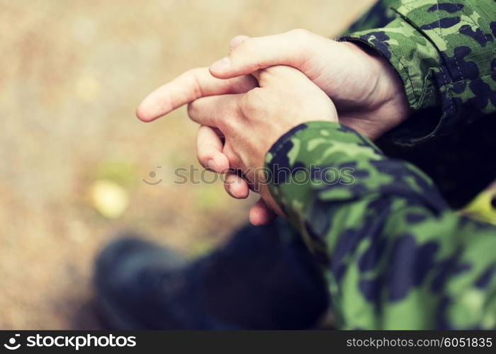 war, army and people concept - close up of young soldier in military uniform