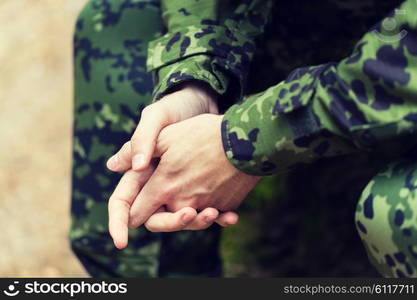 war, army and people concept - close up of young soldier in military uniform