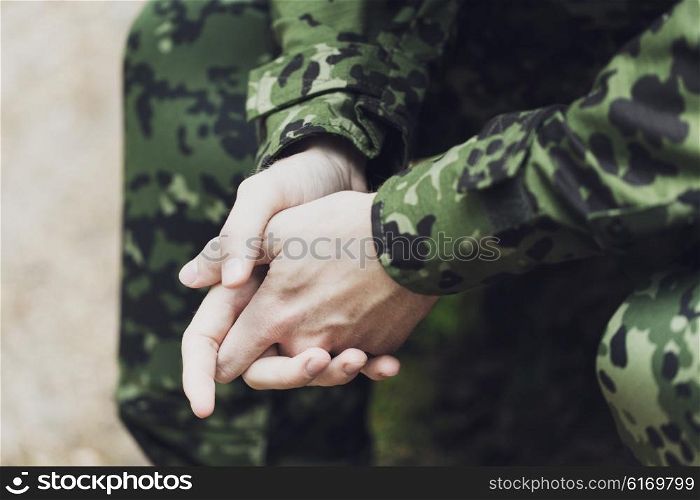 war, army and people concept - close up of young soldier in military uniform