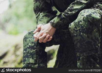 war, army and people concept - close up of young soldier in military uniform