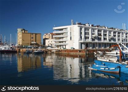 warehouse, fishing boat and sail boat in Genoa port, Italy