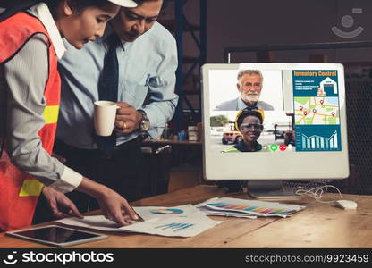 Warehouse staff talking on video call at computer screen in storage warehouse . Online software technology connects people working in logistic factory by virtual conference call on internet network .. Warehouse staff talking on video call at computer screen in storage warehouse