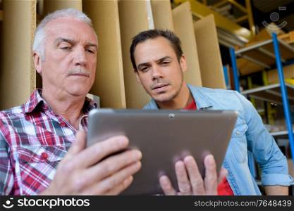 warehouse team working on digital tablet in warehouse