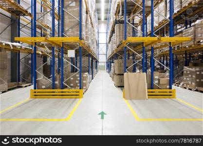 Warehouse with racks and shelves, filled with cardboard boxes, wrapped in foil on wooden pallets