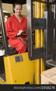 Warehouse worker in forklift