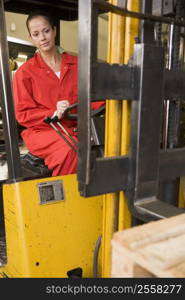 Warehouse worker in forklift