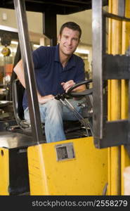 Warehouse worker in forklift