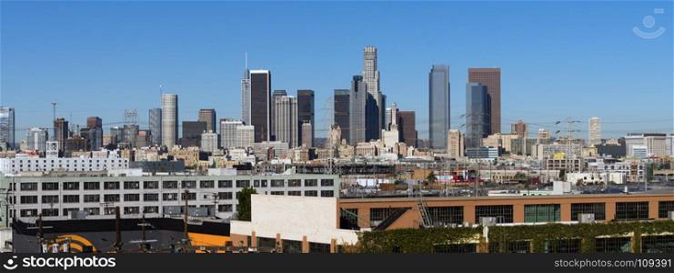 Warehouses and industrial buildings dominate the foreground of this urban view in Los Angeles