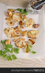 Warm appetizer of fried pieces of cauliflower with garlic and onion