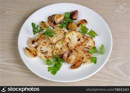 Warm appetizer of fried pieces of cauliflower with garlic and onion