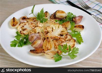 Warm appetizer of fried pieces of cauliflower with garlic and onion