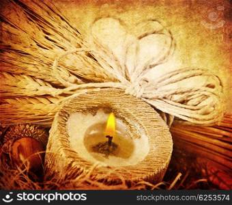 Warm candle light, decoration with wheat, dark grunge autumn background, thanksgiving holiday ornament