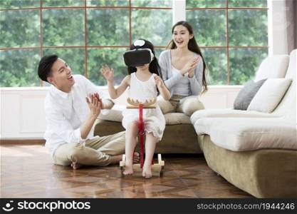 Warm family of three wearing VR glasses