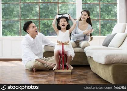 Warm family of three wearing VR glasses